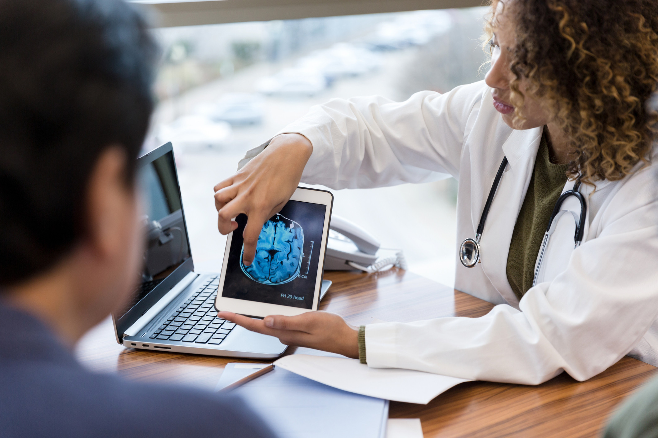 doctor showing head scan